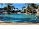 Enjoy the clear water of this large resort pool surrounded by palms and comfortable seating areas at 7602 Cabana Ct # 101, Reunion, FL 34747