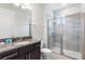 Clean bathroom with a single sink vanity, granite countertop, and a glass-enclosed shower at 7649 Wilmington Loop, Kissimmee, FL 34747