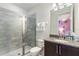 Modern bathroom featuring a glass-enclosed shower, granite counters, and white towels at 7649 Wilmington Loop, Kissimmee, FL 34747