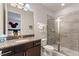 Stylish bathroom featuring a granite countertop, spacious vanity, and a modern glass-enclosed shower for convenience at 7649 Wilmington Loop, Kissimmee, FL 34747