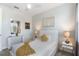 Bright bedroom with white walls, two side tables and lamps, and a queen-size bed with yellow accents at 7649 Wilmington Loop, Kissimmee, FL 34747