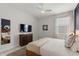 Well-lit bedroom featuring a cozy bed, modern furniture, and a large window for natural light and comfort at 7649 Wilmington Loop, Kissimmee, FL 34747