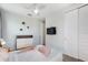 Bedroom with hardwood floors, dresser, closet, and a full-size bed with peach accents at 7649 Wilmington Loop, Kissimmee, FL 34747
