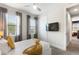 Bright bedroom with large windows, sliding closet, and a mounted TV at 7649 Wilmington Loop, Kissimmee, FL 34747