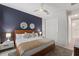 Comfortable bedroom with a king bed, stylish accent wall, and ample closet space for a serene retreat at 7649 Wilmington Loop, Kissimmee, FL 34747