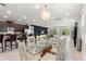 Open concept dining room and kitchen with island seating, modern light fixture, and access to backyard at 7649 Wilmington Loop, Kissimmee, FL 34747