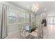 Dining room with large bright windows, seating for eight and direct access to the staircase and front door at 7649 Wilmington Loop, Kissimmee, FL 34747