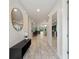 Inviting entryway featuring a large decorative mirror, decorative lighting, and tile flooring throughout the home at 7649 Wilmington Loop, Kissimmee, FL 34747