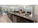 Spacious kitchen island featuring granite countertops, a stainless steel dishwasher, and backyard access at 7649 Wilmington Loop, Kissimmee, FL 34747