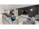 Inviting living room with contemporary decor, a modern sofa, and open layout to the kitchen area at 7649 Wilmington Loop, Kissimmee, FL 34747