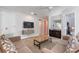 Bright living room with a sleek entertainment center and comfortable seating at 7649 Wilmington Loop, Kissimmee, FL 34747