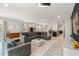 Spacious living room featuring neutral paint, tile flooring, recessed lighting, and an open layout with an island at 7649 Wilmington Loop, Kissimmee, FL 34747