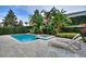 This backyard pool features tropical landscaping and an integrated jacuzzi, perfect for relaxation and entertaining at 7649 Wilmington Loop, Kissimmee, FL 34747