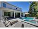 Beautiful backyard pool with lounge chairs and patio area, perfect for relaxing and enjoying the sun at 7649 Wilmington Loop, Kissimmee, FL 34747