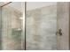Modern bathroom shower featuring tiled walls and glass door at 7649 Wilmington Loop, Kissimmee, FL 34747
