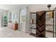 Cozy sitting area with neutral paint, tile floors, two windows, and a wooden cabinet with stylish bookshelf at 7649 Wilmington Loop, Kissimmee, FL 34747