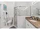 Modern bathroom with glass-enclosed shower, toilet, and granite-topped vanity at 7706 Water Oak Ct, Kissimmee, FL 34747