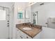 Bathroom featuring a granite countertop, ample lighting, and an adjoining space at 7706 Water Oak Ct, Kissimmee, FL 34747