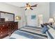 Bedroom featuring a large dresser, TV, ensuite bathroom, and tiled flooring throughout at 7706 Water Oak Ct, Kissimmee, FL 34747