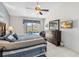 Bedroom featuring a dresser, TV, ceiling fan, and sliding glass doors overlooking the pool at 7706 Water Oak Ct, Kissimmee, FL 34747