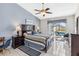 Bedroom with large bed, ceiling fan, and sliding glass doors leading to outdoor pool at 7706 Water Oak Ct, Kissimmee, FL 34747