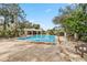 Community pool with chairs and tables available for relaxation at 7706 Water Oak Ct, Kissimmee, FL 34747