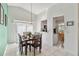 Bright dining area featuring modern chandelier, tile flooring, and views of the kitchen at 7706 Water Oak Ct, Kissimmee, FL 34747