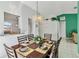 Bright dining area features an elegant chandelier and seating for six at 7706 Water Oak Ct, Kissimmee, FL 34747