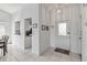 Bright entryway with white tile flooring, white walls, and an open view to the kitchen at 7706 Water Oak Ct, Kissimmee, FL 34747