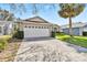 Charming single-story home featuring a well-maintained lawn and a two-car garage at 7706 Water Oak Ct, Kissimmee, FL 34747