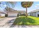 Charming single-story home featuring a well-maintained lawn and a light blue front door at 7706 Water Oak Ct, Kissimmee, FL 34747