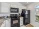 Updated kitchen with stainless steel appliances and granite countertops at 7706 Water Oak Ct, Kissimmee, FL 34747