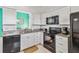 Modern kitchen with stainless steel appliances and granite countertops at 7706 Water Oak Ct, Kissimmee, FL 34747