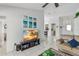 Bright living room with tile flooring, view to the kitchen, and a flat screen TV at 7706 Water Oak Ct, Kissimmee, FL 34747