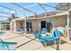 Relaxing pool patio with lounge chairs, table, chairs, and easy access to the home's interior at 7706 Water Oak Ct, Kissimmee, FL 34747