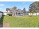 A beautiful screened-in pool with backyard and green grass at 7706 Water Oak Ct, Kissimmee, FL 34747
