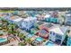 Overhead view of colorful houses with neatly maintained lawns and private swimming pools at 8029 Sandy Toes Way, Kissimmee, FL 34747