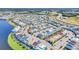 A beautiful aerial view of a colorful neighborhood by the water, with houses, parking, and green spaces at 8029 Sandy Toes Way, Kissimmee, FL 34747