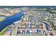 An aerial view showing a community of colorful houses located near a lake and entertainment options at 8029 Sandy Toes Way, Kissimmee, FL 34747