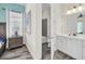 Bright bathroom featuring a white vanity, modern lighting fixtures, and tiled floors at 8029 Sandy Toes Way, Kissimmee, FL 34747