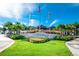 Welcoming entrance to Margaritaville Resort with lush landscaping, flags, and vibrant blue sky at 8029 Sandy Toes Way, Kissimmee, FL 34747