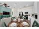 Inviting dining area and kitchen featuring modern appliances and stylish decor at 8029 Sandy Toes Way, Kissimmee, FL 34747
