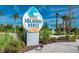 The entrance sign for Island H2O Live! water park with palm trees and various water attractions in view at 8029 Sandy Toes Way, Kissimmee, FL 34747
