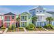 Exterior of vibrant colorful townhomes, professionally landscaped at 8029 Sandy Toes Way, Kissimmee, FL 34747