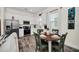 Charming white kitchen with modern appliances, adjacent to a cozy dining area at 8029 Sandy Toes Way, Kissimmee, FL 34747