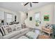Cozy living area with a sofa, decorative pillows, and easy access to dining area at 8029 Sandy Toes Way, Kissimmee, FL 34747
