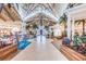 The grand lobby has high ceilings, palm trees, unique light fixtures, and elegant seating areas at 8029 Sandy Toes Way, Kissimmee, FL 34747