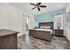 Serene main bedroom with natural light, a comfortable king bed, and stylish furnishings at 8029 Sandy Toes Way, Kissimmee, FL 34747