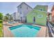 Backyard pool surrounded by palm trees at 8029 Sandy Toes Way, Kissimmee, FL 34747