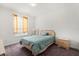 Bright and inviting bedroom features a cozy bed, bedside table, and natural light from the window at 8103 Coconut Palm Way # 204, Kissimmee, FL 34747